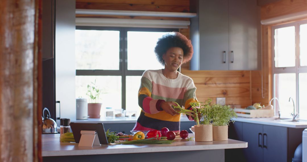 Woman Cooking in Kitchen with Fresh Vegetables and Tablet - Free Images, Stock Photos and Pictures on Pikwizard.com