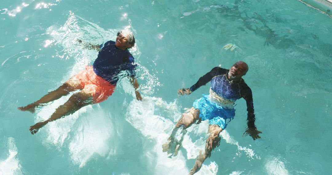 Image of happy senior american african couple exercising in the pool - Free Images, Stock Photos and Pictures on Pikwizard.com