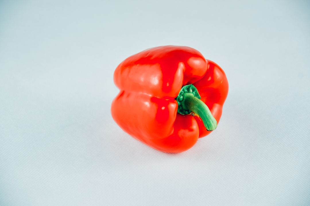 Single Red Bell Pepper on White Background - Free Images, Stock Photos and Pictures on Pikwizard.com