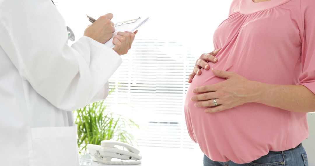 Pregnant Woman Consulting Doctor During Prenatal Check-Up - Free Images, Stock Photos and Pictures on Pikwizard.com