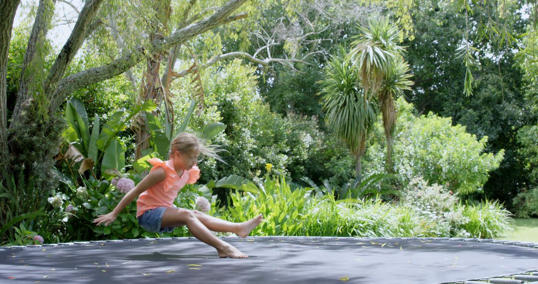 Girl Jumping on Trampoline in Lush Green Garden - Free Images, Stock Photos and Pictures on Pikwizard.com