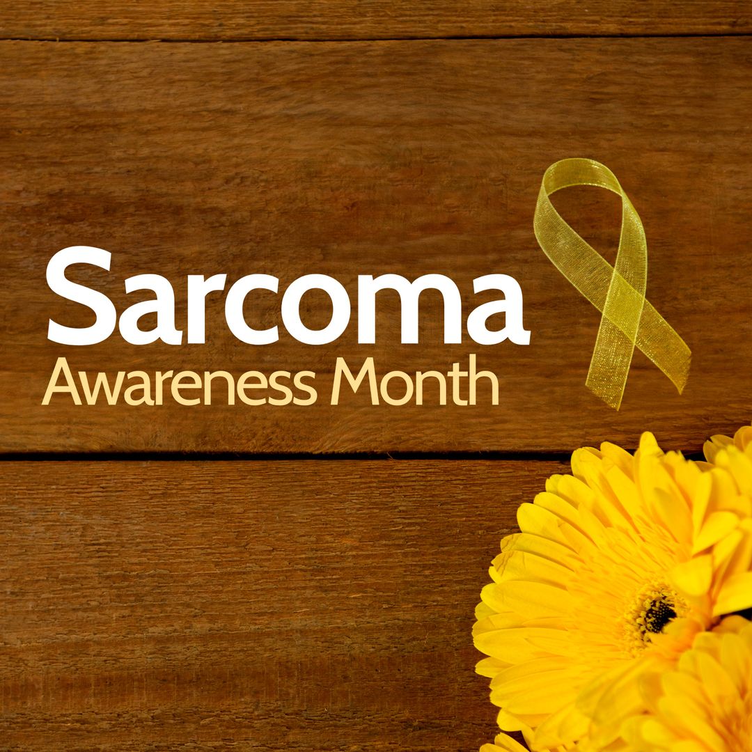 Sarcoma Awareness Month with Yellow Ribbon and Flowers on Wooden Background