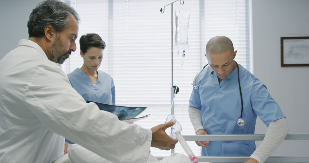 Medical professionals examining patient in hospital room - Free Images, Stock Photos and Pictures on Pikwizard.com