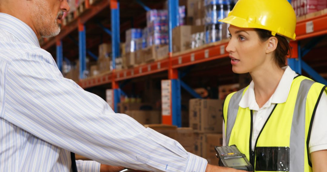 Warehouse Manager Discussing Work Plans with Compliance Officer - Free Images, Stock Photos and Pictures on Pikwizard.com