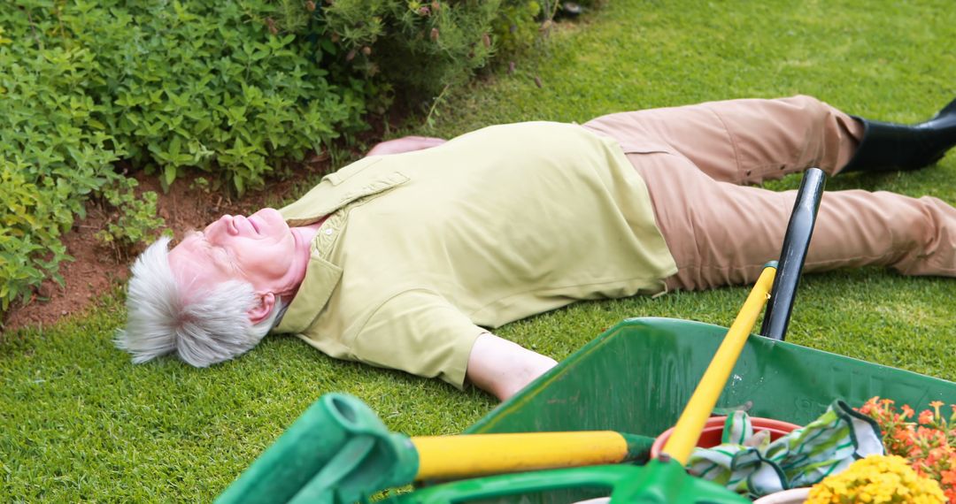 Senior Man Lying on Grass After Gardening with Tools Scattered - Free Images, Stock Photos and Pictures on Pikwizard.com