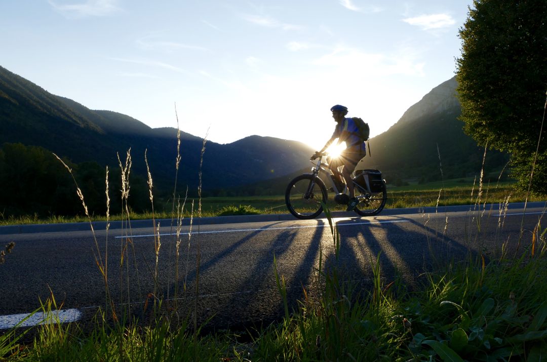 Cyclist Riding through Countryside at Sunset - Free Images, Stock Photos and Pictures on Pikwizard.com