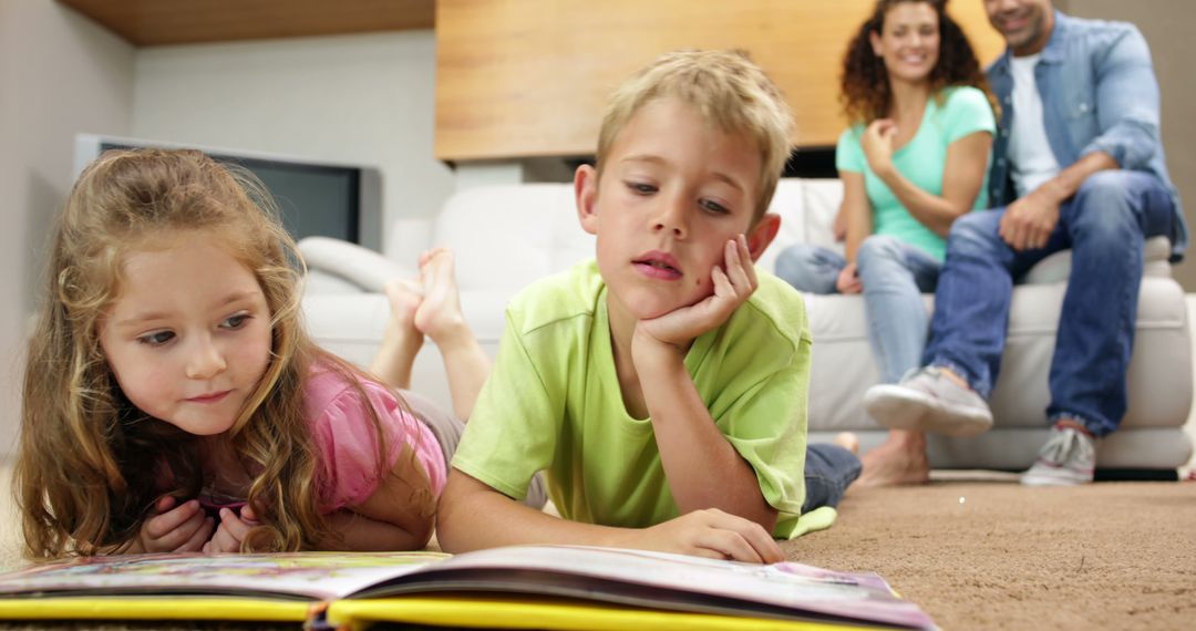 Children Reading a Book on Carpet with Parents in Background - Free Images, Stock Photos and Pictures on Pikwizard.com