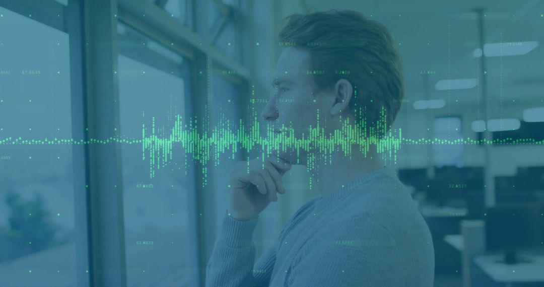 Man Analyzing Financial Data Overlayer in Modern Office Environment