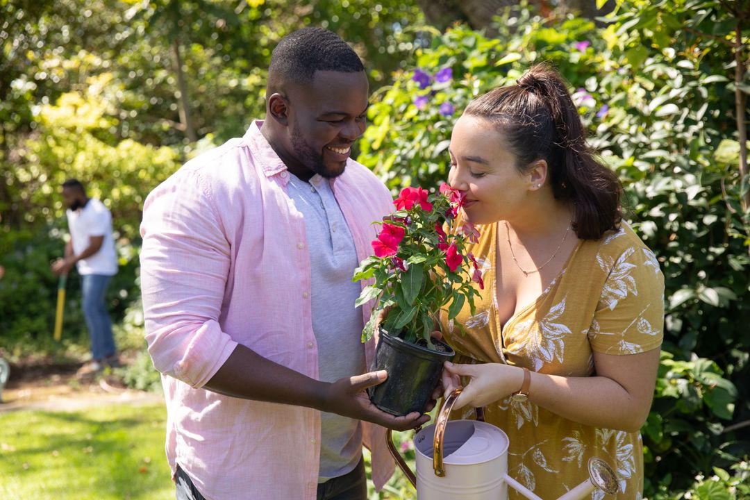 Smiling Diverse Couple Gardening Together in Vibrant Backyard