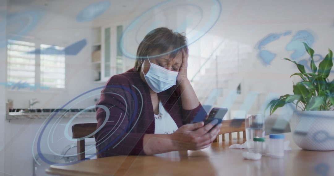Senior Woman with Face Mask Using Smartphone at Home
