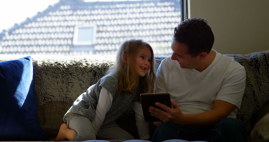 Father and Daughter Bonding at Home with Tablet - Free Images, Stock Photos and Pictures on Pikwizard.com