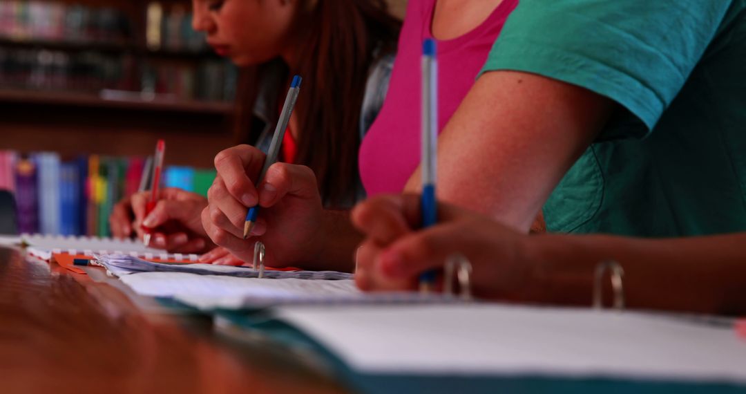 Students Writing Notes in University Library
