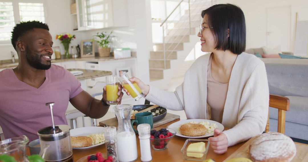 Multiracial Couple Having Breakfast Together at Home - Free Images, Stock Photos and Pictures on Pikwizard.com