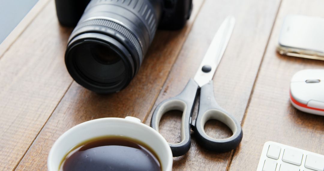 Desk with Coffee Cup, Camera, Scissors, and Office Tools - Free Images, Stock Photos and Pictures on Pikwizard.com