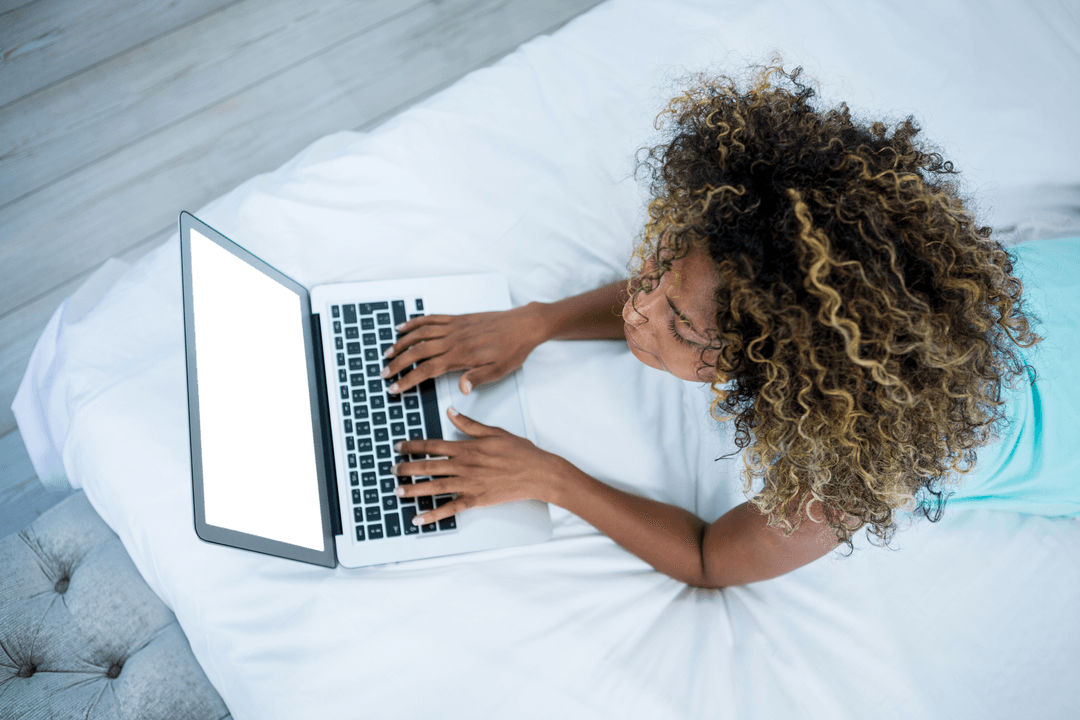 Curly-haired Woman Using Laptop with Transparent Screen at Home