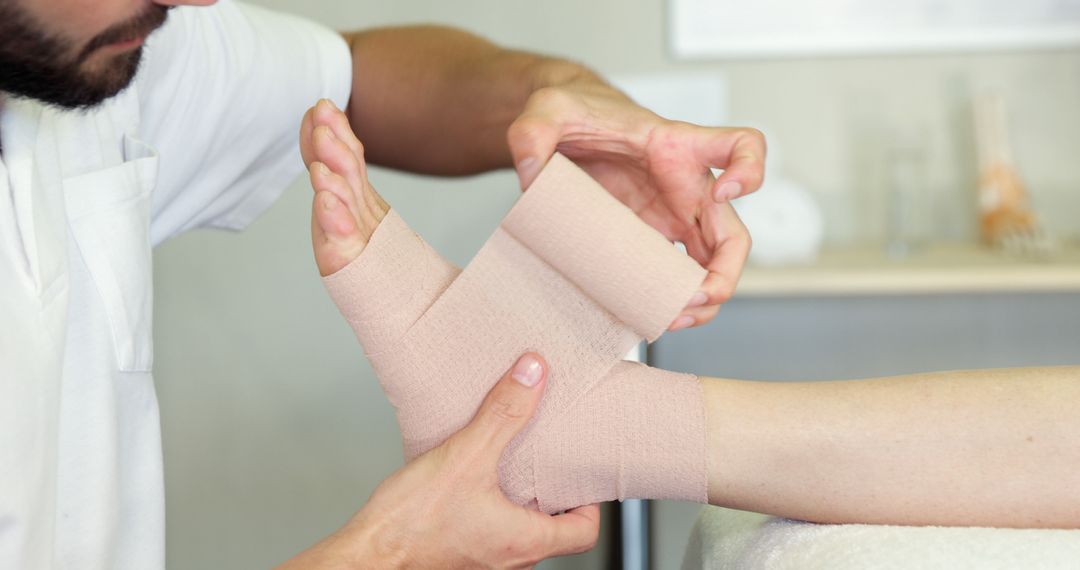 Close-Up of Medical Professional Bandaging Patient's Ankle - Free Images, Stock Photos and Pictures on Pikwizard.com