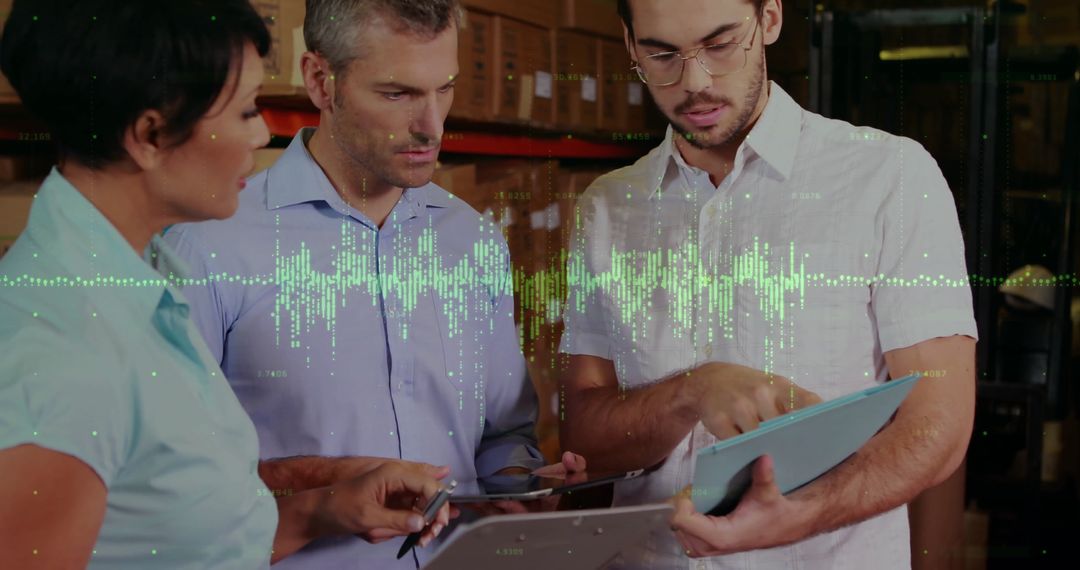 Team Discussing Financial Data in Warehouse with Digital Interface
