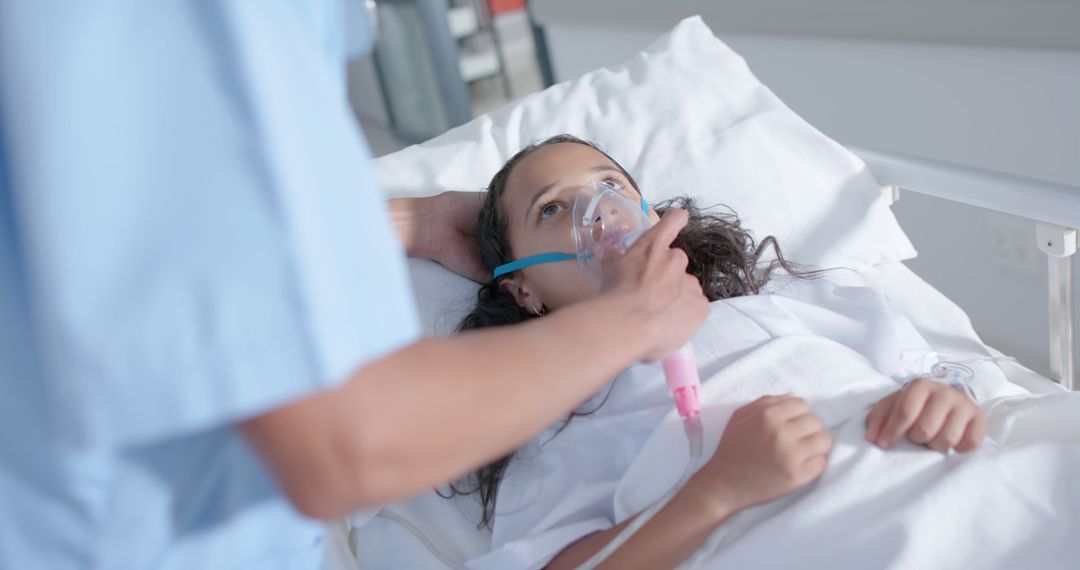 Nurse Caring for Young Girl with Oxygen Mask in Hospital Room - Free Images, Stock Photos and Pictures on Pikwizard.com