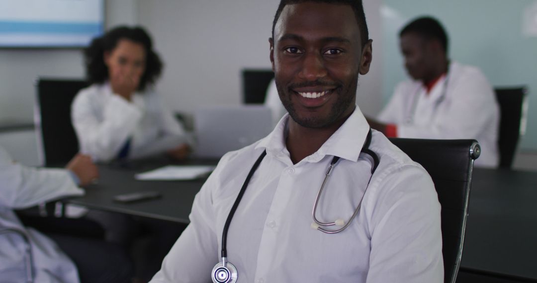 Confident Male Doctor in Modern Office Smiling at Camera - Free Images, Stock Photos and Pictures on Pikwizard.com