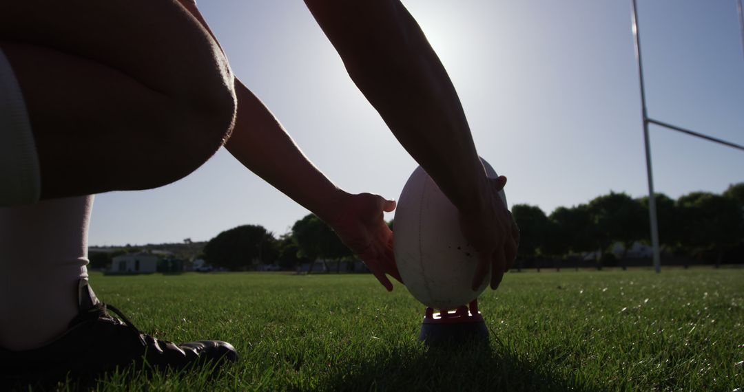 Rugby Player Preparing to Kick Rugby Ball at Sunset - Free Images, Stock Photos and Pictures on Pikwizard.com