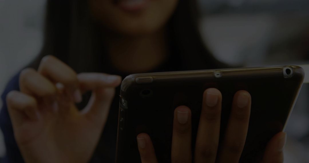 Technologically Savvy Asian Woman Using a Tablet in Office