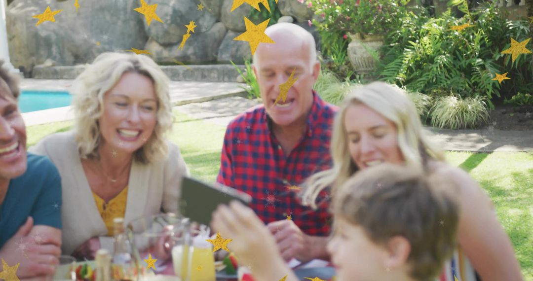 Multi Generation Family Enjoying Outdoor Gathering with Smartphone