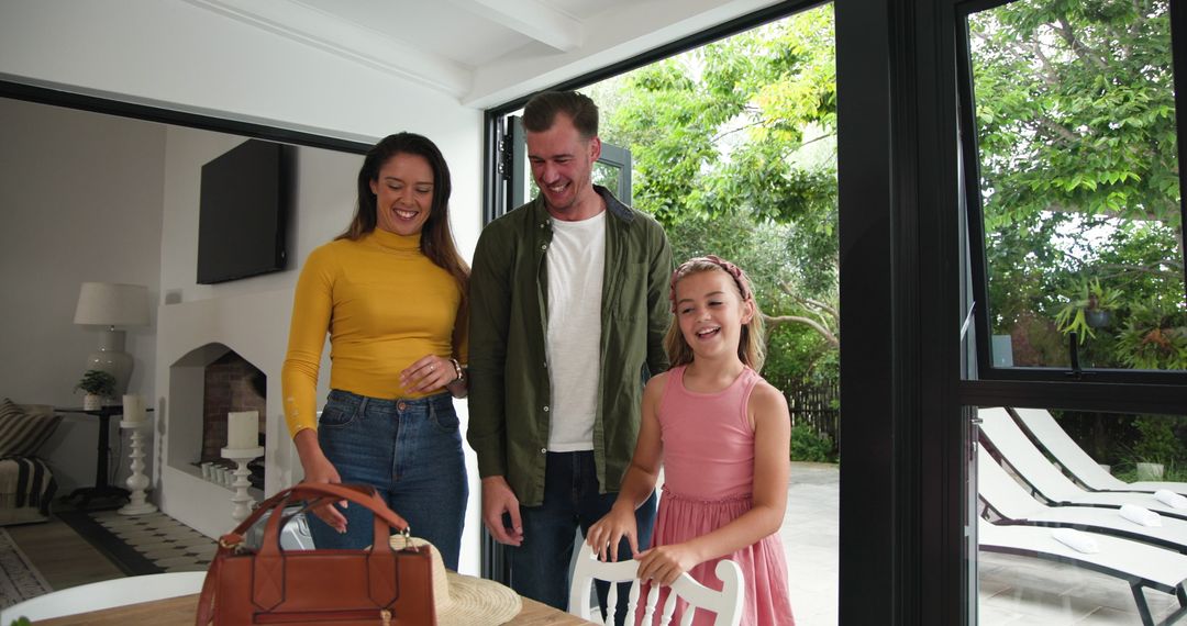 Family Returning Home Embracing and Smiling Near Patio Door