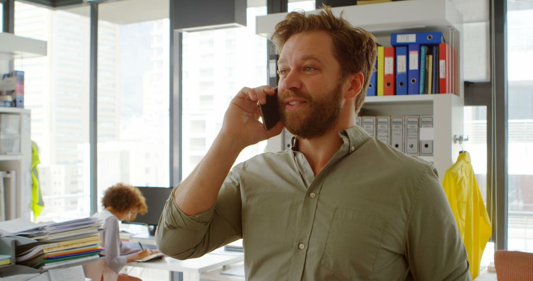 Confident Businessman Talking on Phone in Modern Office - Free Images, Stock Photos and Pictures on Pikwizard.com