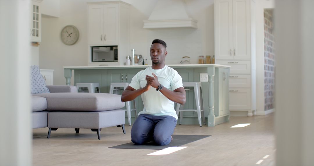 Man Meditating in Modern Living Room - Free Images, Stock Photos and Pictures on Pikwizard.com