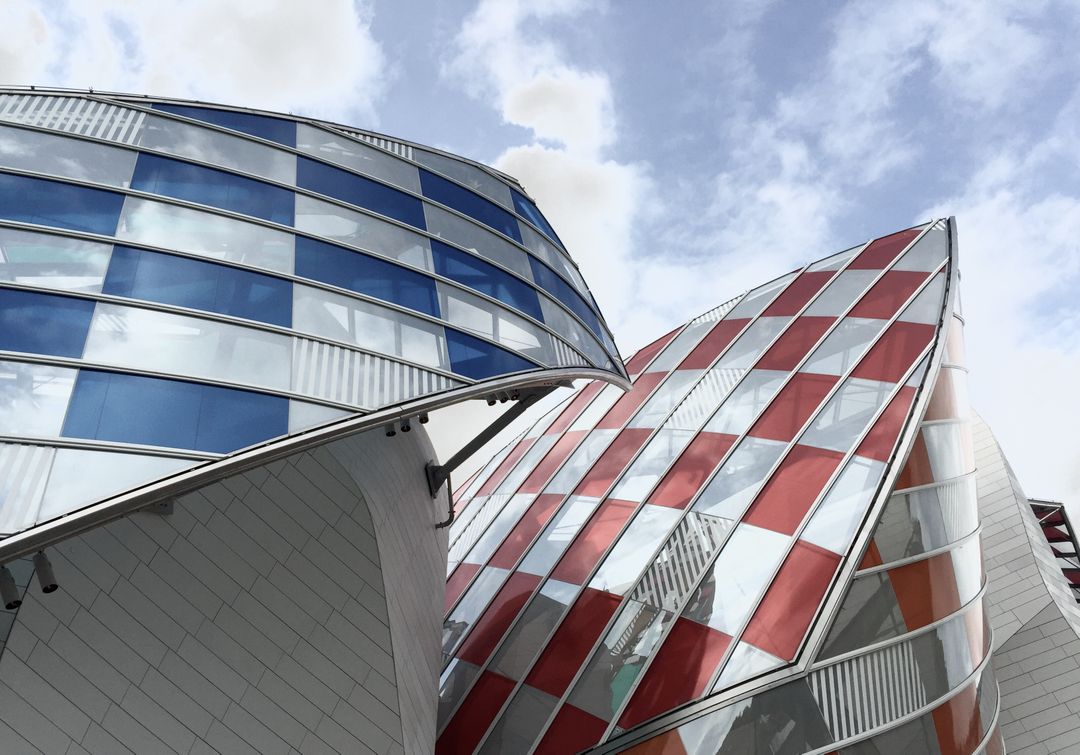 Modern Abstract Architecture Glass and Metal Structure with Red and Blue Panels - Free Images, Stock Photos and Pictures on Pikwizard.com