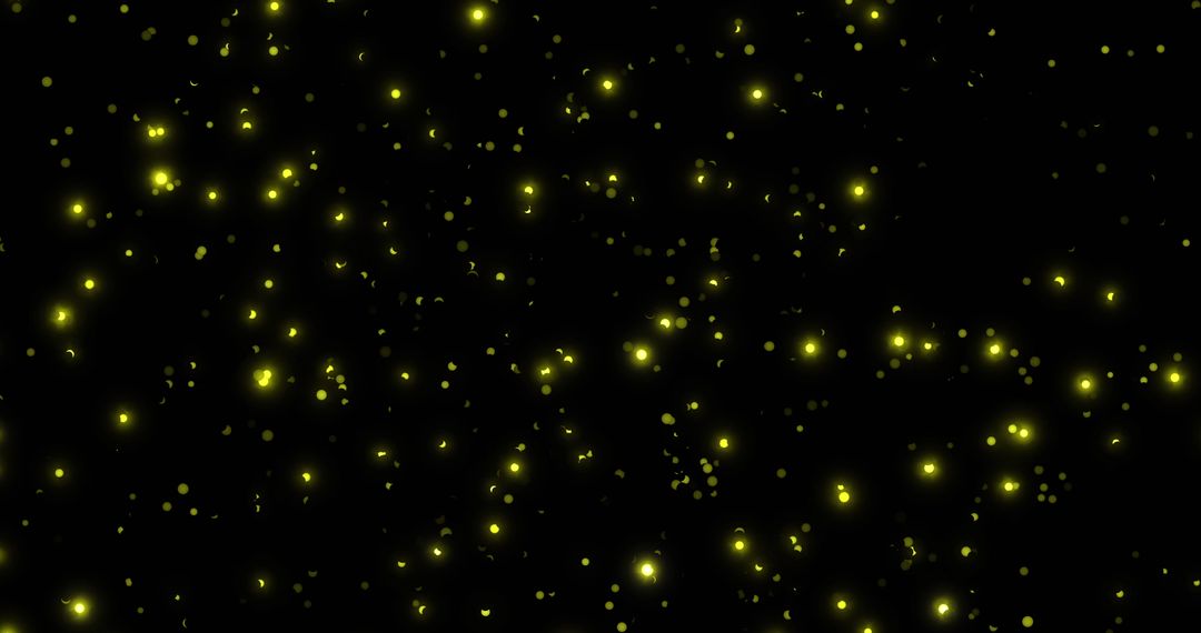 Glowing Yellow Particles on Black Background