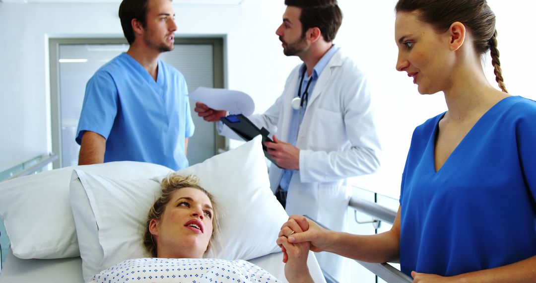 Hospital staff comforting female patient in bed, discussing medical chart - Free Images, Stock Photos and Pictures on Pikwizard.com