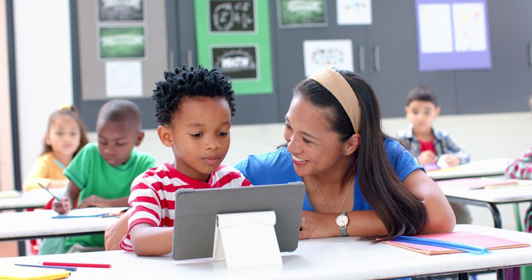 Teacher Guiding Student with Tablet in Interactive Classroom