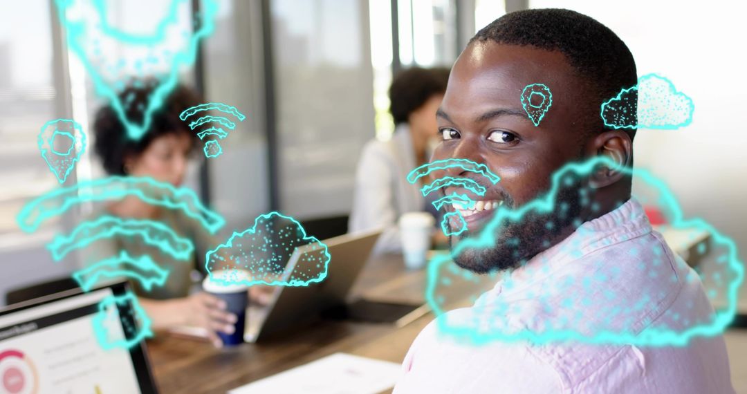 Smiling bearded man turning toward camera in office using AR cloud graphics for teamwork
