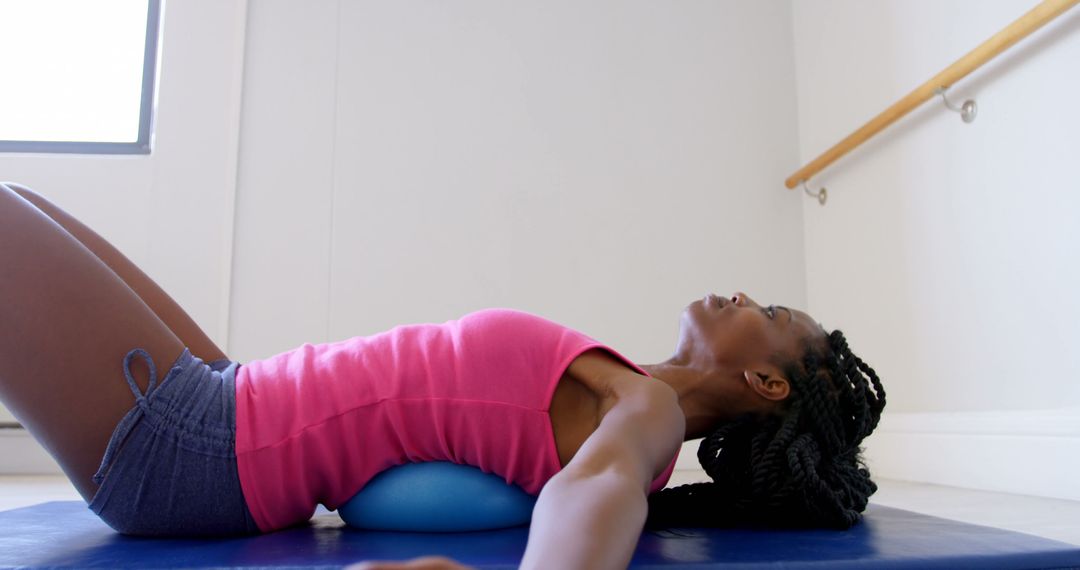 Woman Stretching During Yoga Session on Blue Mat - Free Images, Stock Photos and Pictures on Pikwizard.com