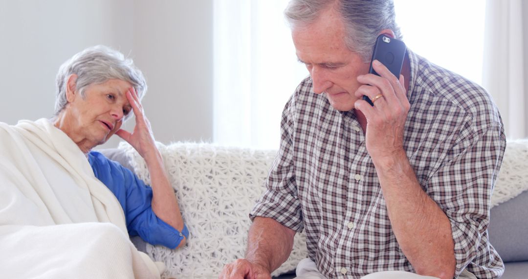 Senior Couple Making an Emergency Call in Living Room - Free Images, Stock Photos and Pictures on Pikwizard.com