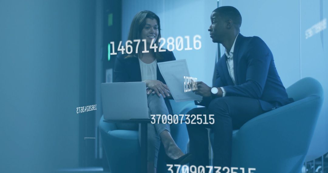 Business Professionals Discussing Data in Modern Office Lounge