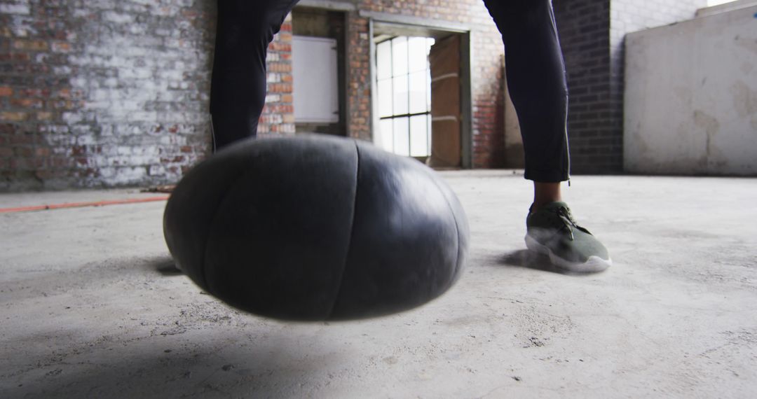 Athlete Performing Medicine Ball Slam in Industrial Gym - Free Images, Stock Photos and Pictures on Pikwizard.com