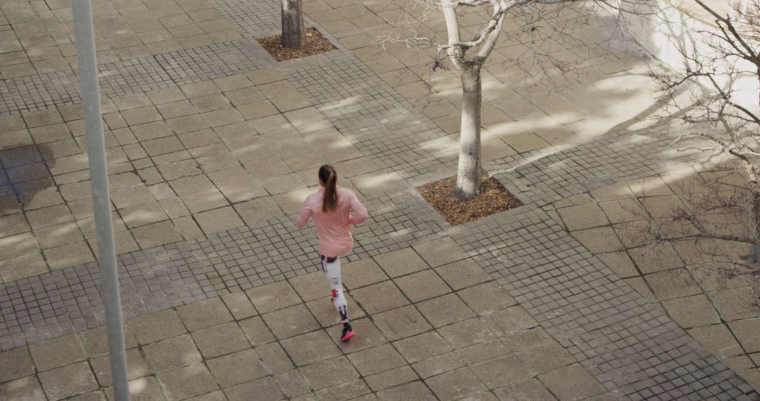 Woman Jogging on Paved Path in Urban Area - Free Images, Stock Photos and Pictures on Pikwizard.com