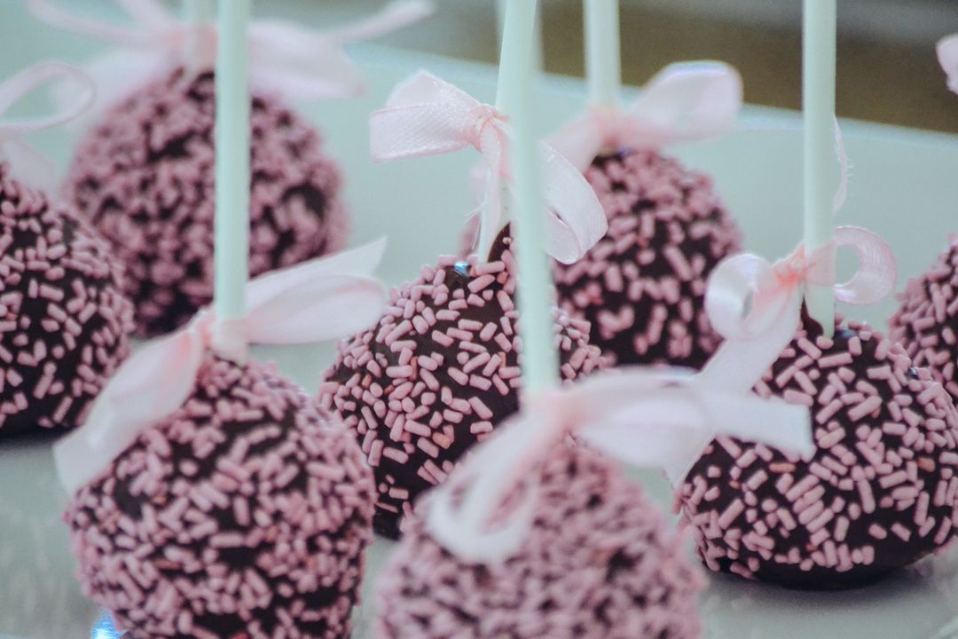 Close-Up of Chocolate Cake Pops with Pink Sprinkles and Ribbons - Free Images, Stock Photos and Pictures on Pikwizard.com