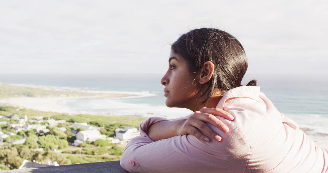 Image of thoughtful biracial woman by sea looking into distance - Free Images, Stock Photos and Pictures on Pikwizard.com