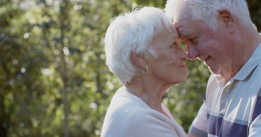 Happy Senior Couple Embracing in Sunny Garden