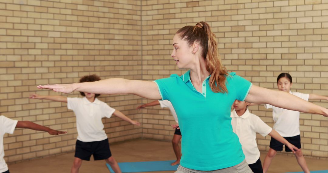 Instructor Leading Yoga Class for Children in Gym - Free Images, Stock Photos and Pictures on Pikwizard.com