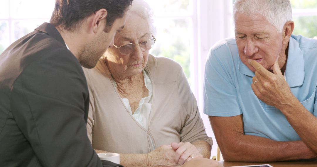 Professional Financial Advisor Reviewing Documents with Senior Couple