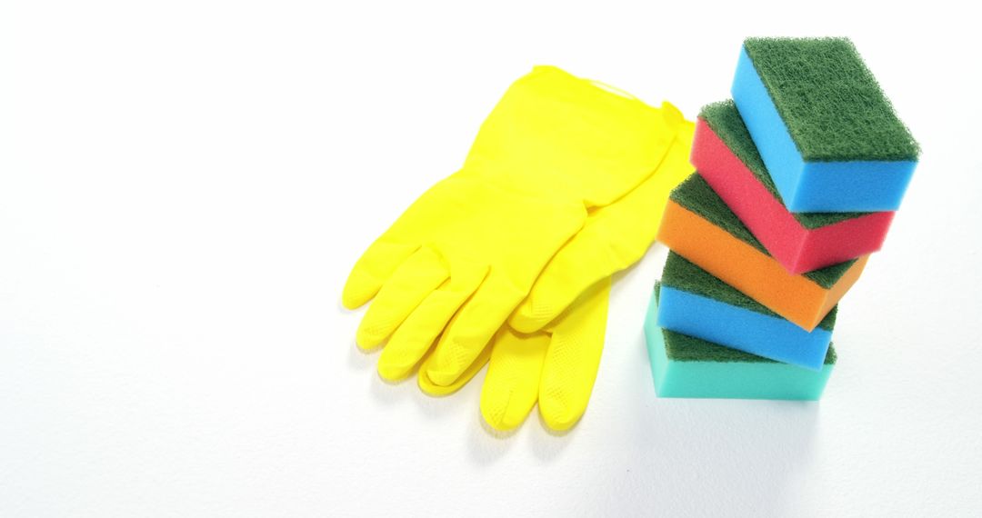 Yellow Cleaning Gloves and Colorful Sponges on White Background - Free Images, Stock Photos and Pictures on Pikwizard.com