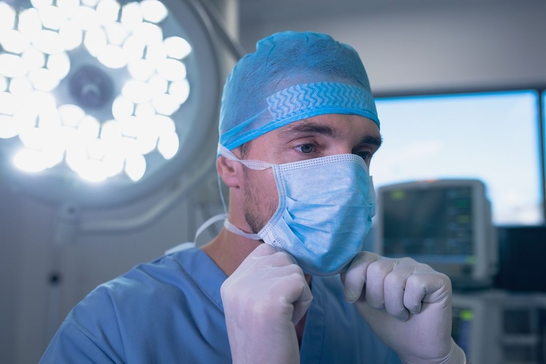 Male surgeon wearing surgical mask in operation room - Free Images, Stock Photos and Pictures on Pikwizard.com