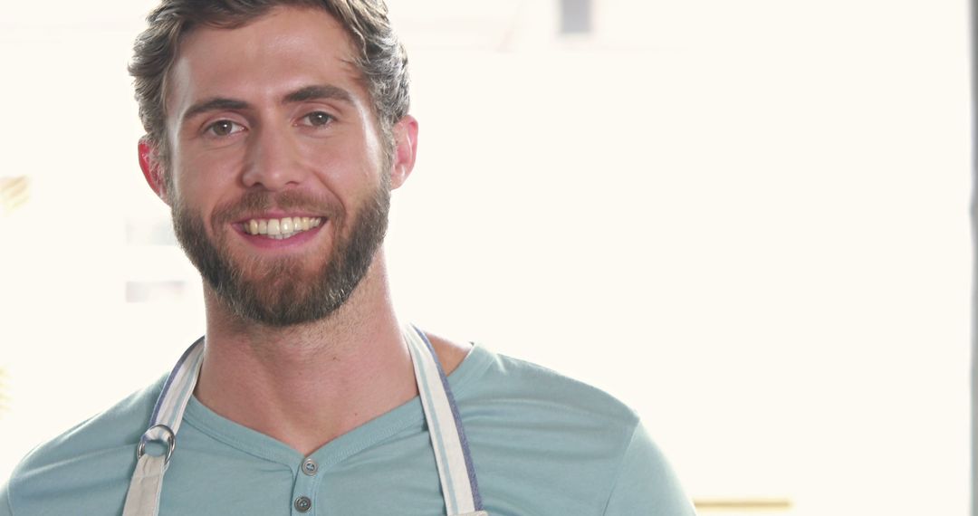 Smiling Man Wearing Apron in Kitchen - Free Images, Stock Photos and Pictures on Pikwizard.com