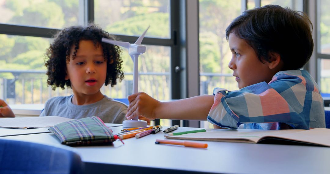 Schoolchildren Engaging With Wind Turbine Model in Classroom