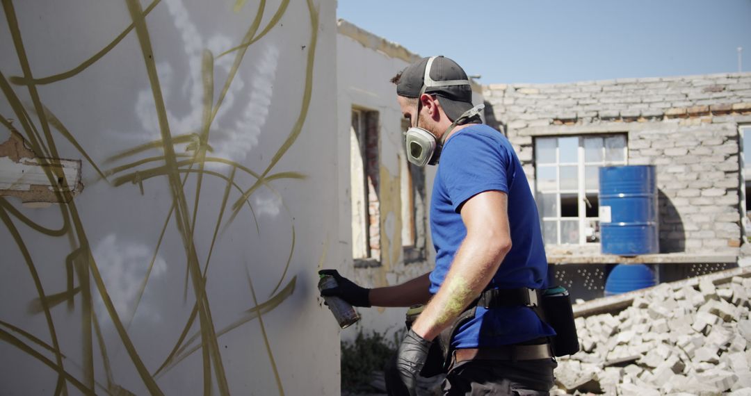 Construction Worker Spraying Graffiti on Wall at Rebuild Site - Free Images, Stock Photos and Pictures on Pikwizard.com