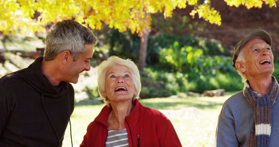 Elderly Friends Enjoying Outdoors in Autumn Park - Free Images, Stock Photos and Pictures on Pikwizard.com